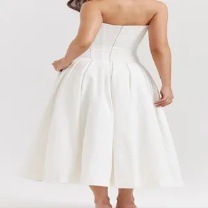 Detailed back view of a white strapless A-line dress with elegant pleats and zipper