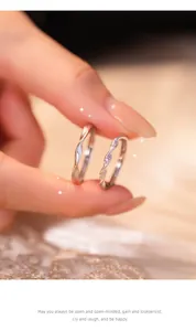 Close-up of Mobius sterling silver couple rings with sparkling zirconia stones.