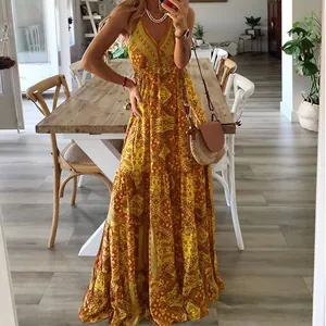 Boho chic yellow floral v-neck maxi dress with high waist detail in a home setting.