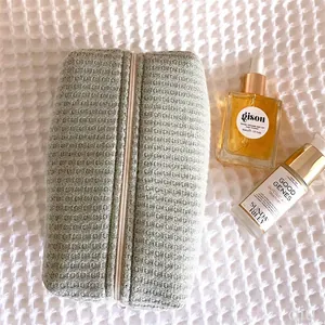 Sage green waffle textured cosmetic travel bag with zipper closure for toiletries
