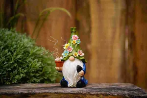 Close-up of a solar garden gnome ornament with flowers on its hat holding a small pot