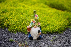 Hand-painted garden gnome ornament with decorative flowers and solar string lights