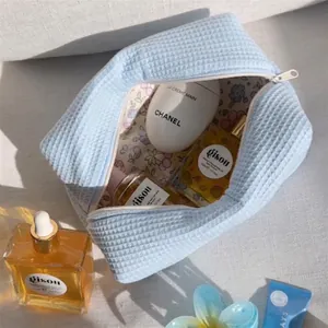 Large capacity light blue waffle knit travel makeup bag with floral interior lining