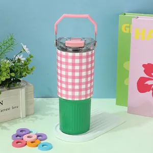 Close-up of a pink plaid and green insulated tumbler with a handle