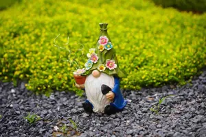 Adorable solar garden gnome statue with flower hat and LED lights in outdoor garden setting