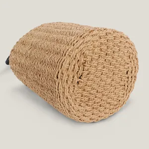 Handcrafted cylindrical woven straw beach bag showing detailed bottom and side weave