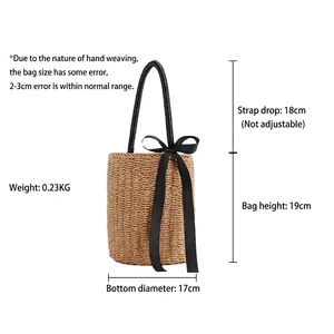 Cylindrical straw woven handbag with black ribbon bow decoration for summer beach