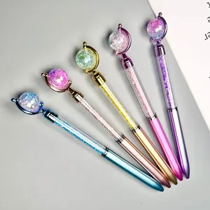 Detailed view of five creative planet top ballpoint pens with colorful glitter beads