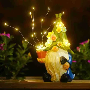 Hand-painted solar garden gnome ornament featuring a glowing flower hat and LED lights