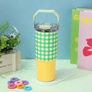 Detail view of 30oz checkered insulated tumbler with handle and straw lid in green