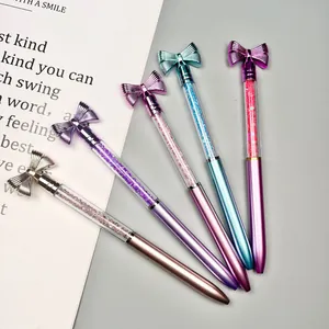 Close-up of elegant bow-knot ballpoint pens with shimmering crystal-filled barrels in various colors