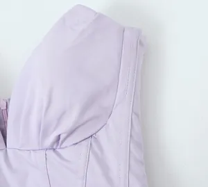 Close-up detail of a lavender pleated corset dress showing fabric texture and stitching