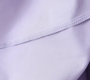 Detailed macro shot of fine stitching on a lavender purple summer dress fabric