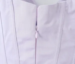 Close-up detail of the smooth high-quality hidden zipper on a light purple summer dress.