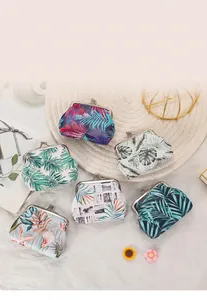 Detail of tropical palm leaf print coin purses with elegant metal kiss-lock clasp
