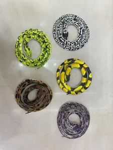 Detailed view of realistic coiled rubber toy snakes in various colors and realistic patterns.