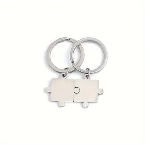 Detailed close-up of interlocking puzzle piece keychains in polished stainless steel.