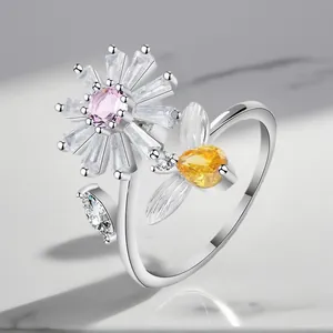 Detailed view of an adjustable silver-plated ring featuring a crystal flower and bee