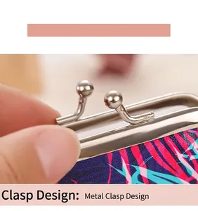 Close-up of the metal kiss-lock clasp on a tropical palm leaf print coin purse.