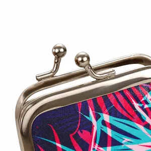 Close-up of the metal kiss-lock clasp on a tropical palm leaf print coin purse.