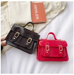 Glossy jelly Cambridge style satchel bags in black and pink with buckle details