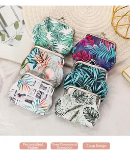 Detailed view of assorted tropical palm leaf print clasp coin purses on textured backgrounds