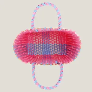 Top view of a colorful hand-woven plastic picnic basket featuring pink and blue stripes