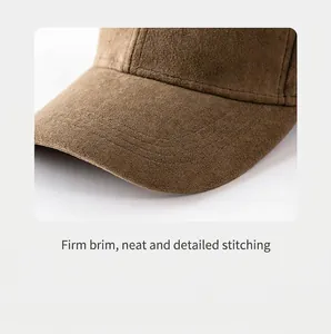 Macro view of the neat stitching and soft suede texture on a brown baseball cap brim.