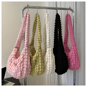 Large capacity popcorn textured cloud shoulder bags in various colors on a rack