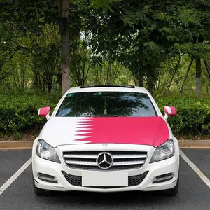 Detailed view of Qatar flag car hood cover and side mirror sleeves on a white vehicle