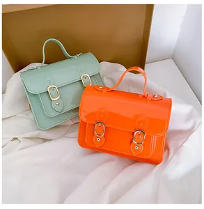 Summer jelly Cambridge bags in mint green and orange with magnetic buckle straps.