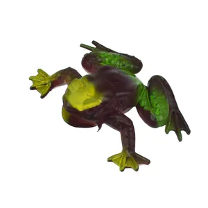 Close-up detail of a realistic soft rubber frog toy with vibrant green and yellow markings