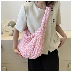 Detailed macro view of a pink bubble popcorn texture cloud bag worn as a trendy shoulder bag.