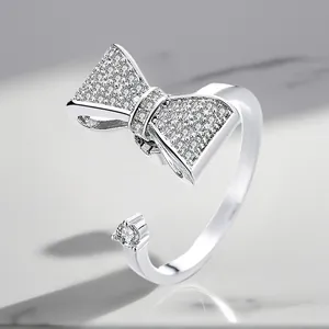 Close-up of silver-plated adjustable ring featuring sparkling zircon bow motif.