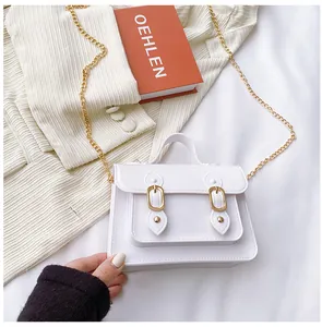 Detailed view of a white jelly Cambridge crossbody bag with gold chain and buckle