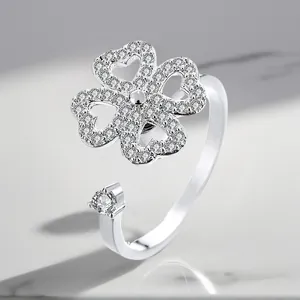 Close-up of adjustable silver-plated rotating ring with sparkling zircon clover design