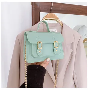 Close-up of mint green jelly Cambridge crossbody bag with elegant gold chain strap