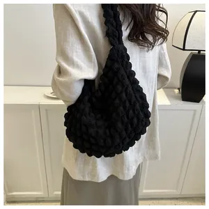 Black bubble textured cloud underarm bag shown on model for daily commute style