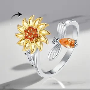 Detailed macro view of adjustable rotating sunflower and bee ring with amber cubic zircons