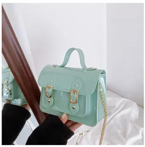 Close-up of a mint green jelly Cambridge bag with glossy finish and gold chain