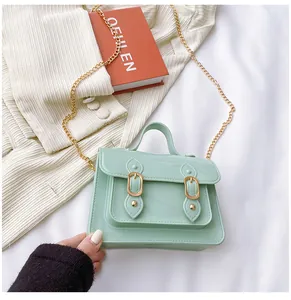 Detail view of a stylish mint green jelly Cambridge bag with golden chain strap