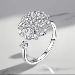 Detailed macro view of an adjustable silver ring with rotating zircon flower motif