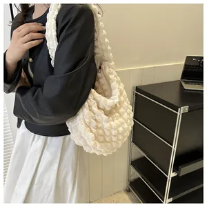 Close-up detail of a white popcorn textured cloud shoulder bag for women daily commuting