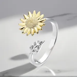 Detailed macro view of an adjustable sunflower ring with gold and silver tones.