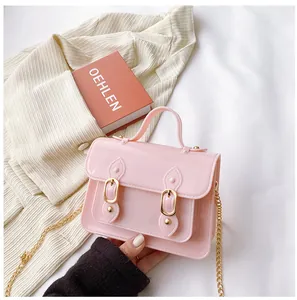 Stylish pink jelly Cambridge crossbody bag with gold chain strap for summer style.