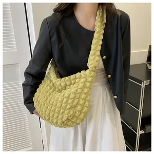 Close-up detail of a yellow bubble textured cloud crossbody bag for women's daily commute