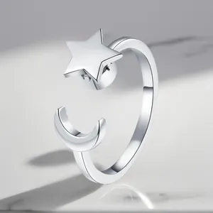 Detailed macro view of an adjustable silver-plated rotating ring with star and moon motifs