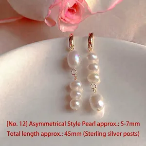 Macro view of asymmetric natural freshwater pearl earrings showing elegant luster detail