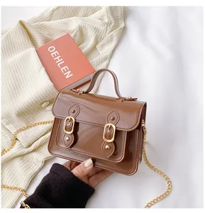 Brown jelly Cambridge crossbody bag with gold buckles and chic chain strap