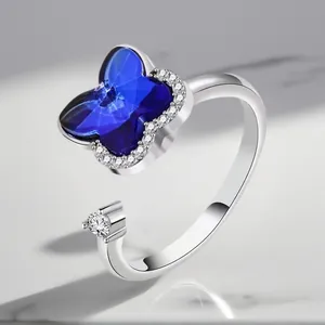 Detailed view of silver adjustable spinner ring featuring a blue butterfly crystal.